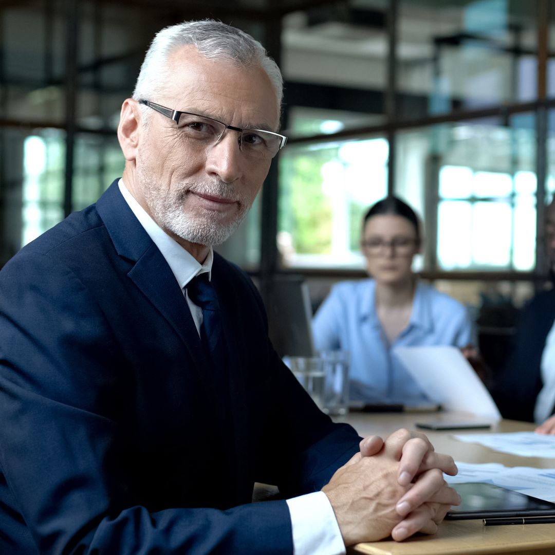 a man looking a the camera smiling after speaking to employer advice about the ACAS code of practice